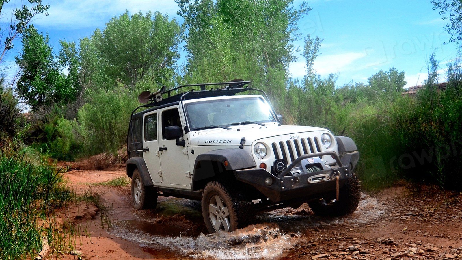 An organized rear cargo area of a 4x4 vehicle packed with essential overlanding gear on a dusty outback trail.