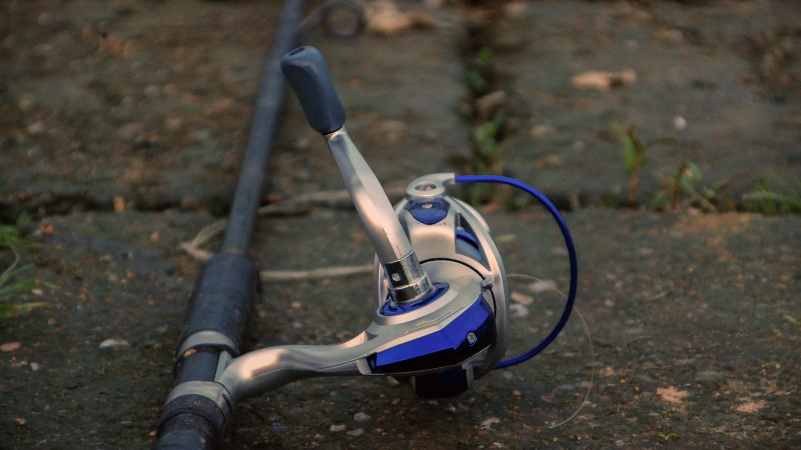 A fully rigged fishing kayak resting on a sandy riverbank at dawn, ready for an Australian angling adventure.