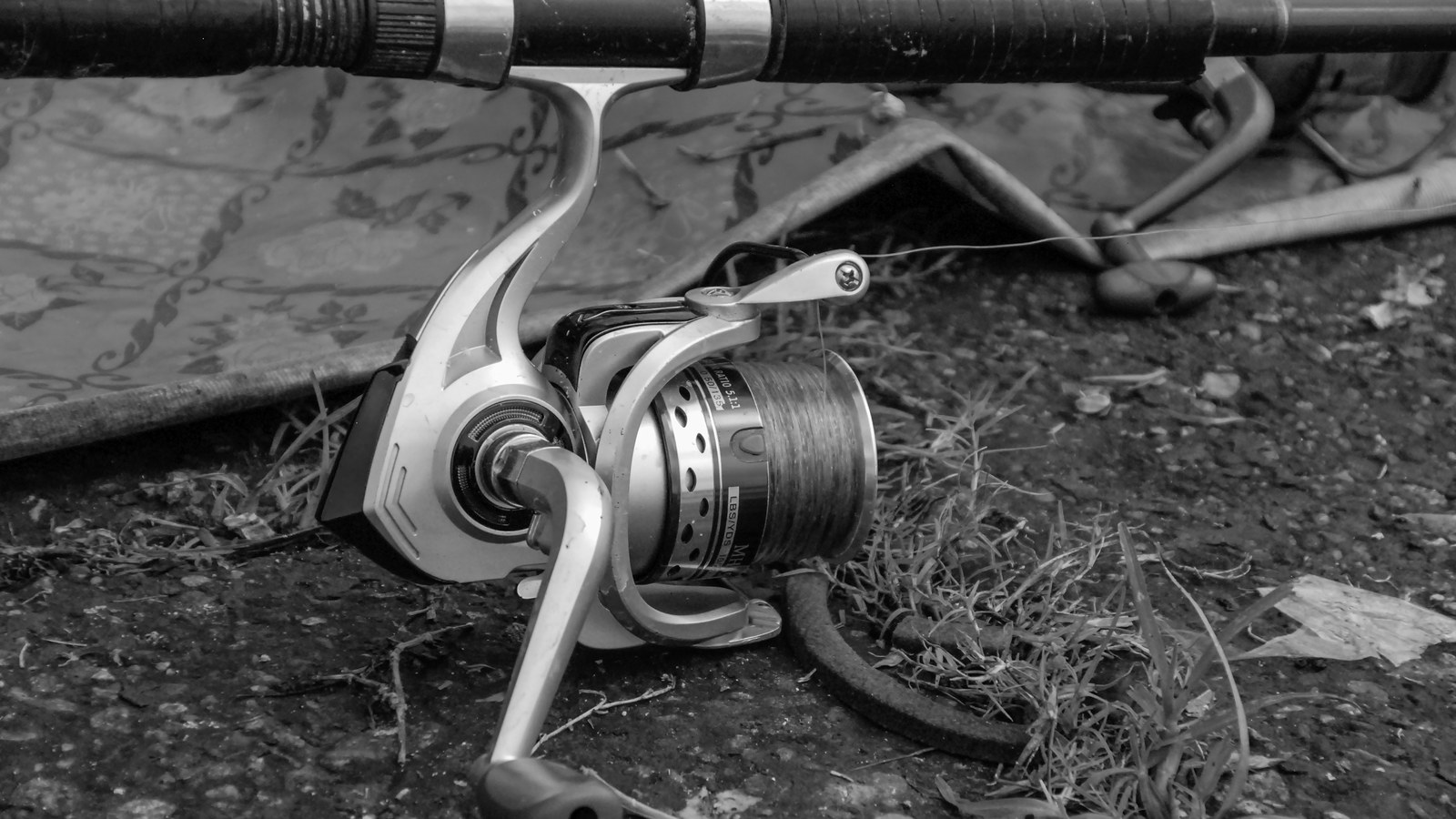 A sturdy fishing rod storage rack mounted on a garage wall holding multiple rods securely.
