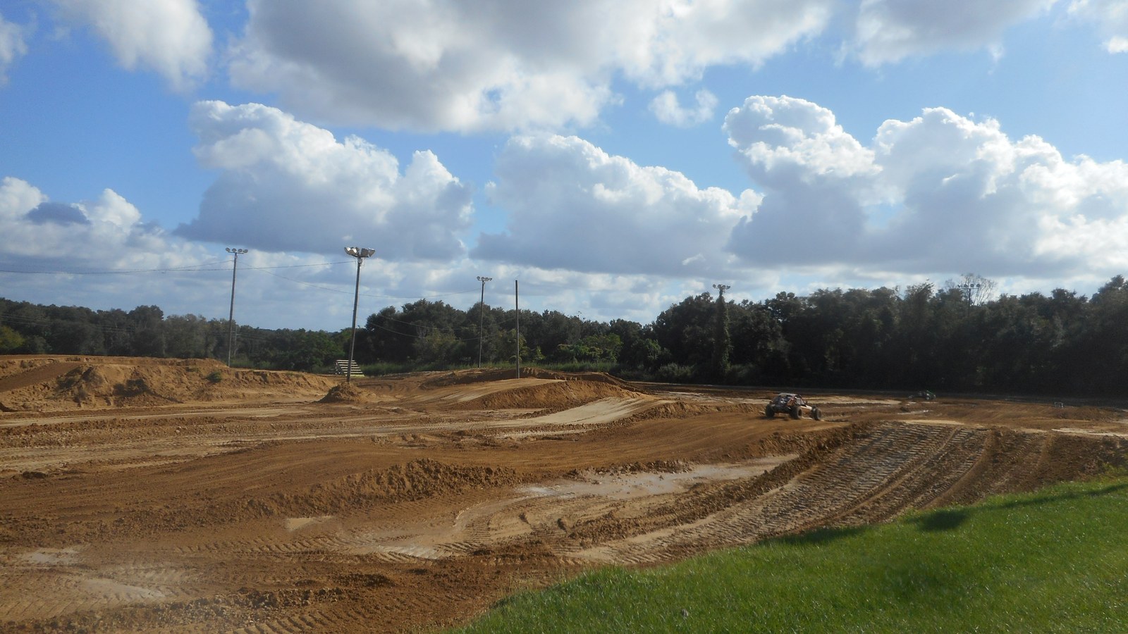 A heavy-duty portable air compressor inflating a large 4WD tyre on a dusty outback track.
