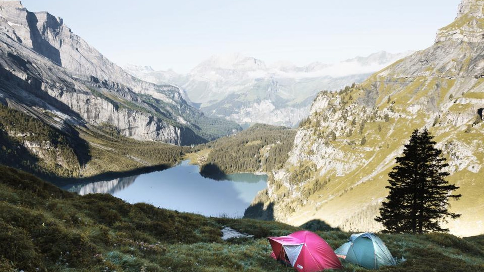 A thick self-inflating sleeping mat set up inside a camping tent for a comfortable night outdoors.
