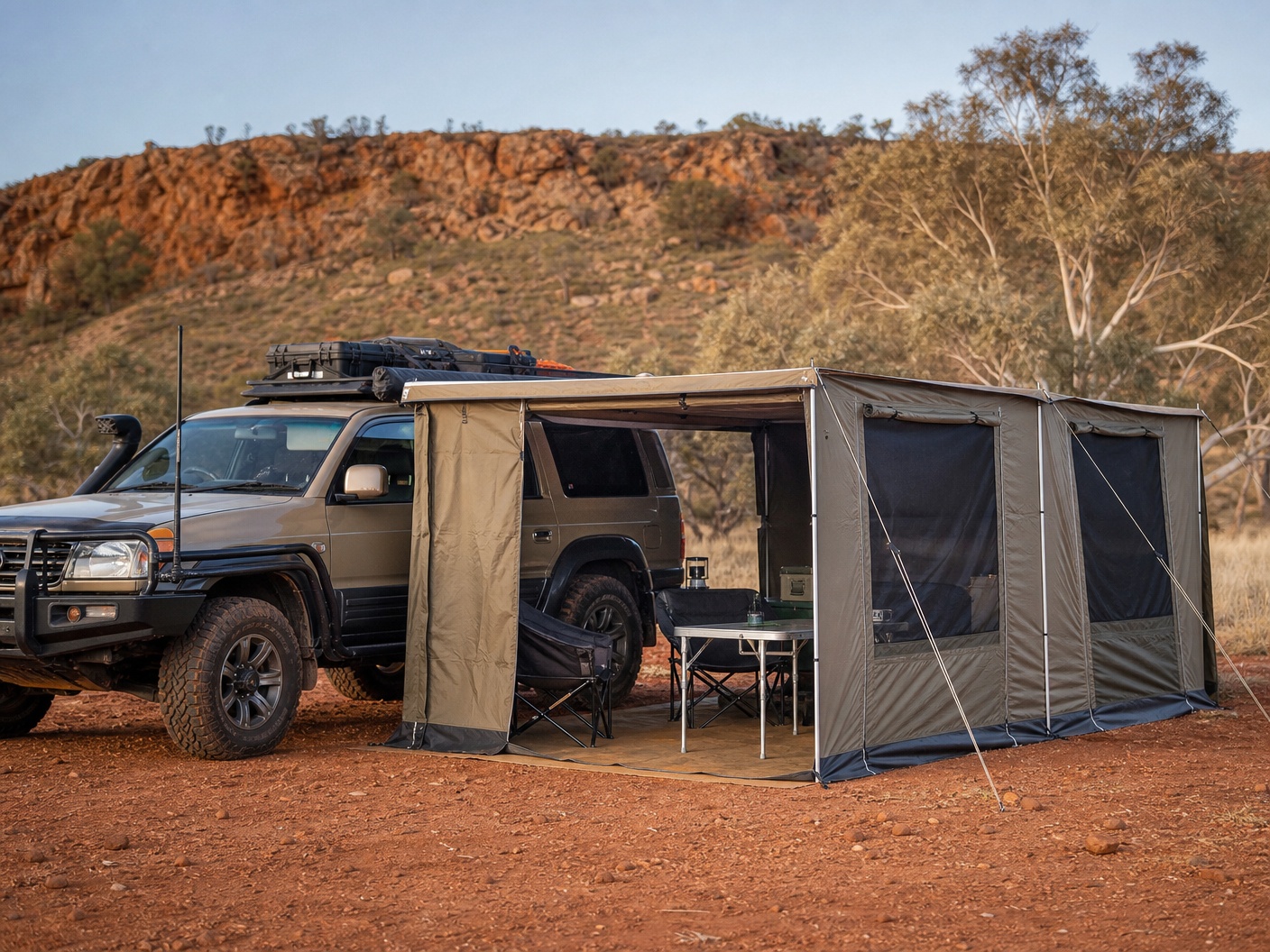 4x4 awning wall room kit attached to an overlanding vehicle at a red dirt campsite