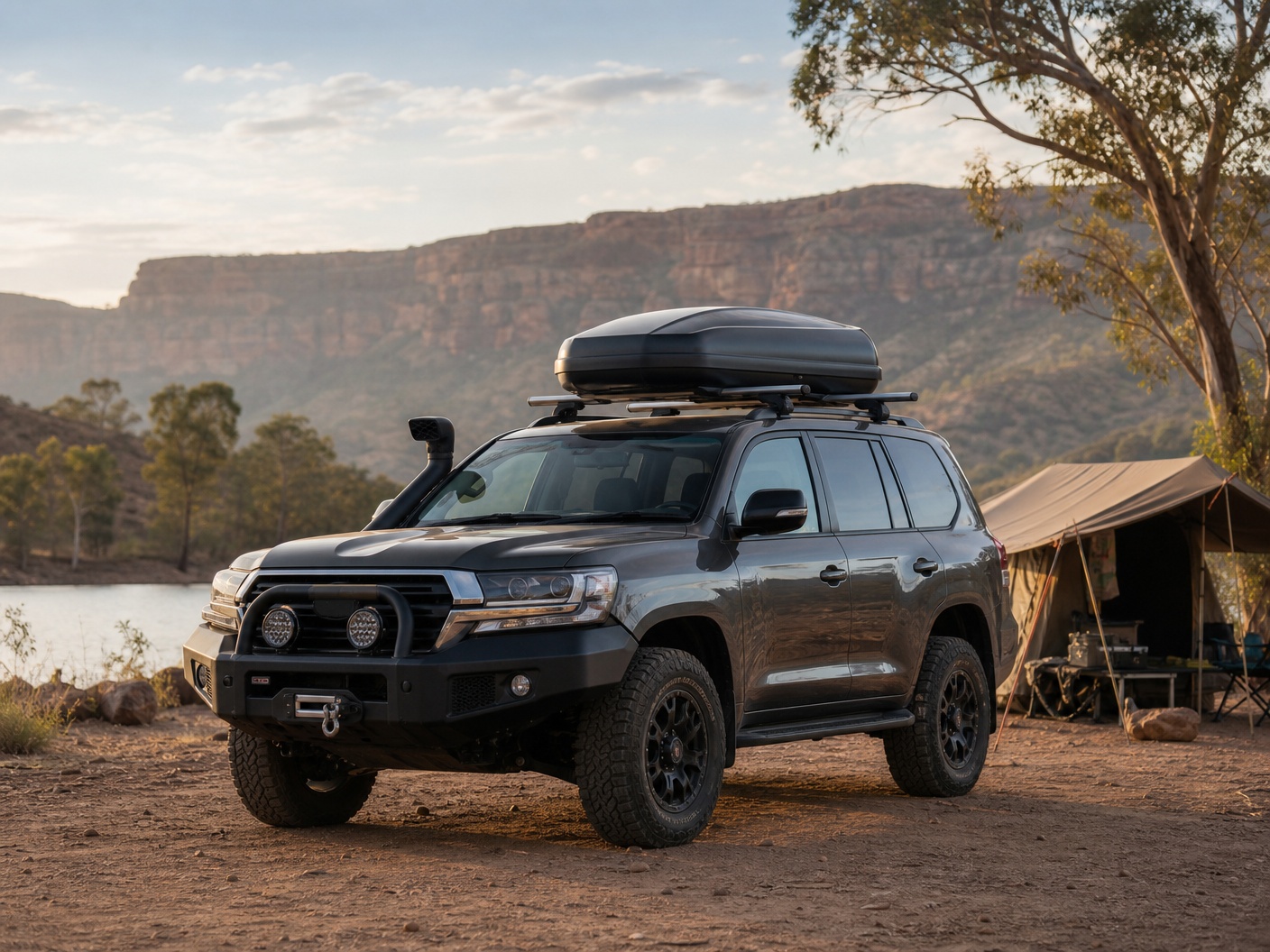 Roof cargo box mounted on a 4x4 touring vehicle at a campsite