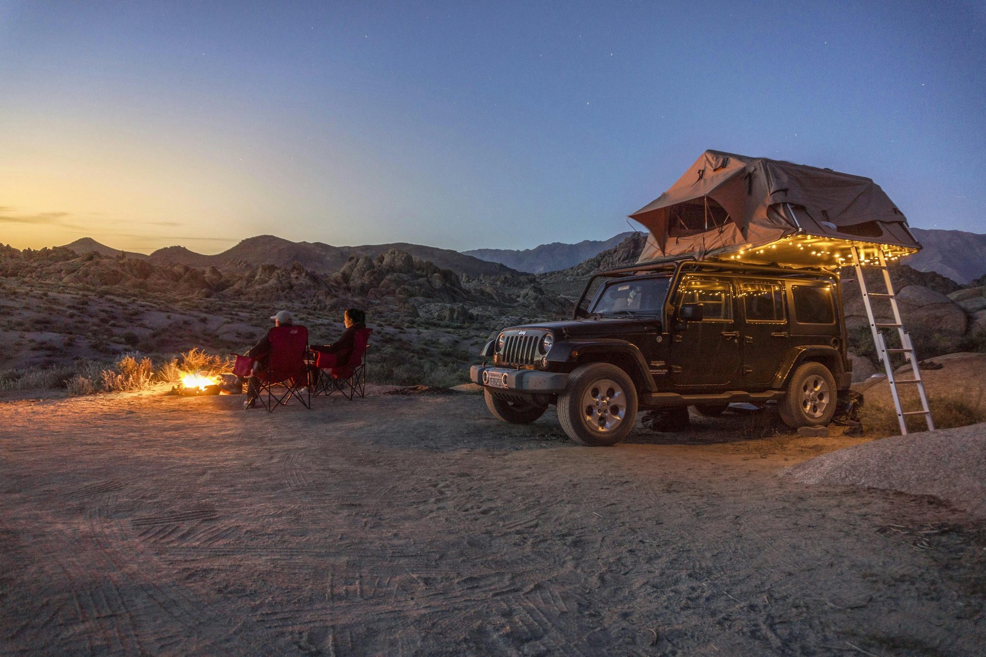 Rooftop tent opened on an overlanding vehicle at a remote campsite