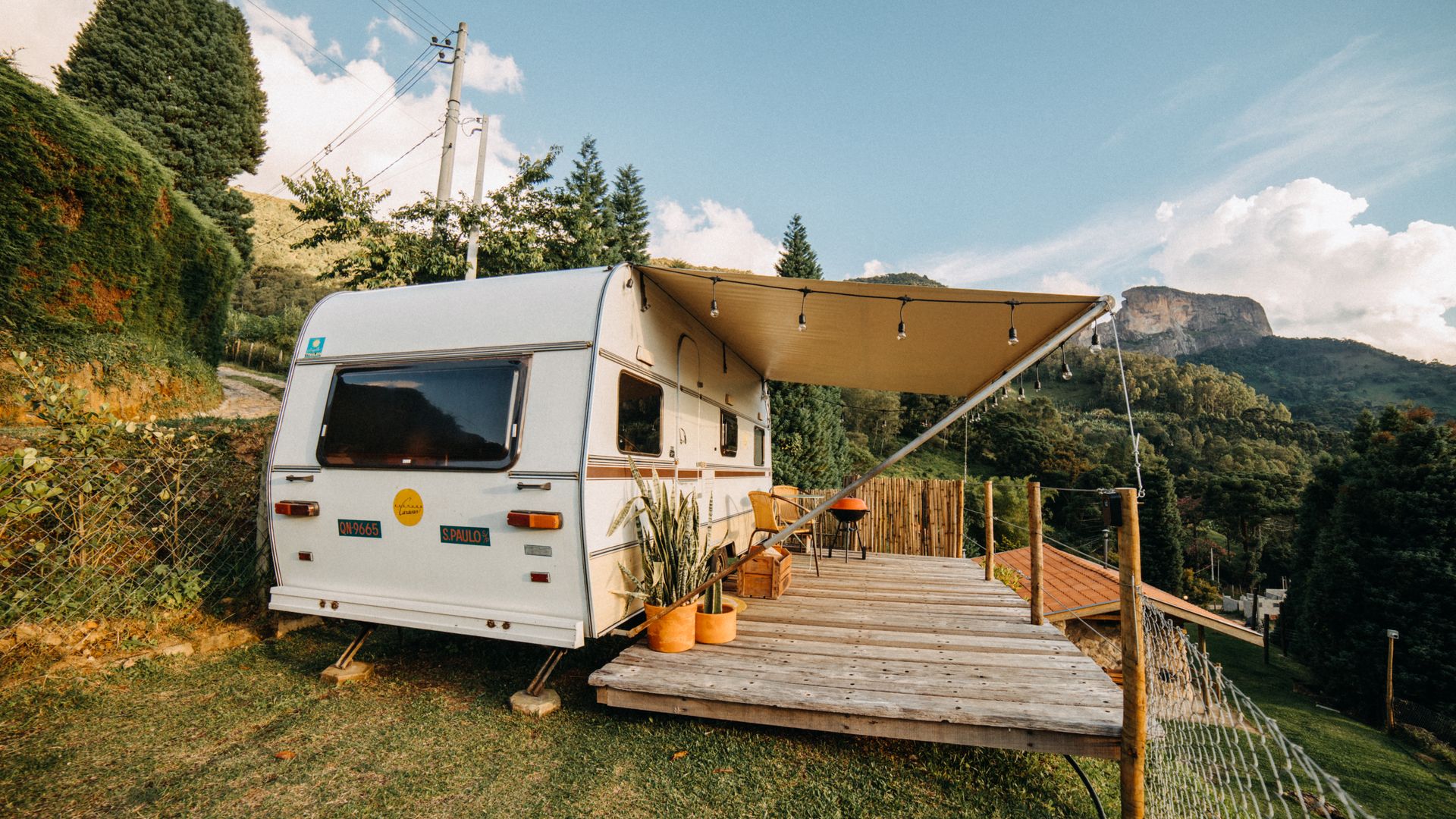 Caravan set up with an awning on a level campsite