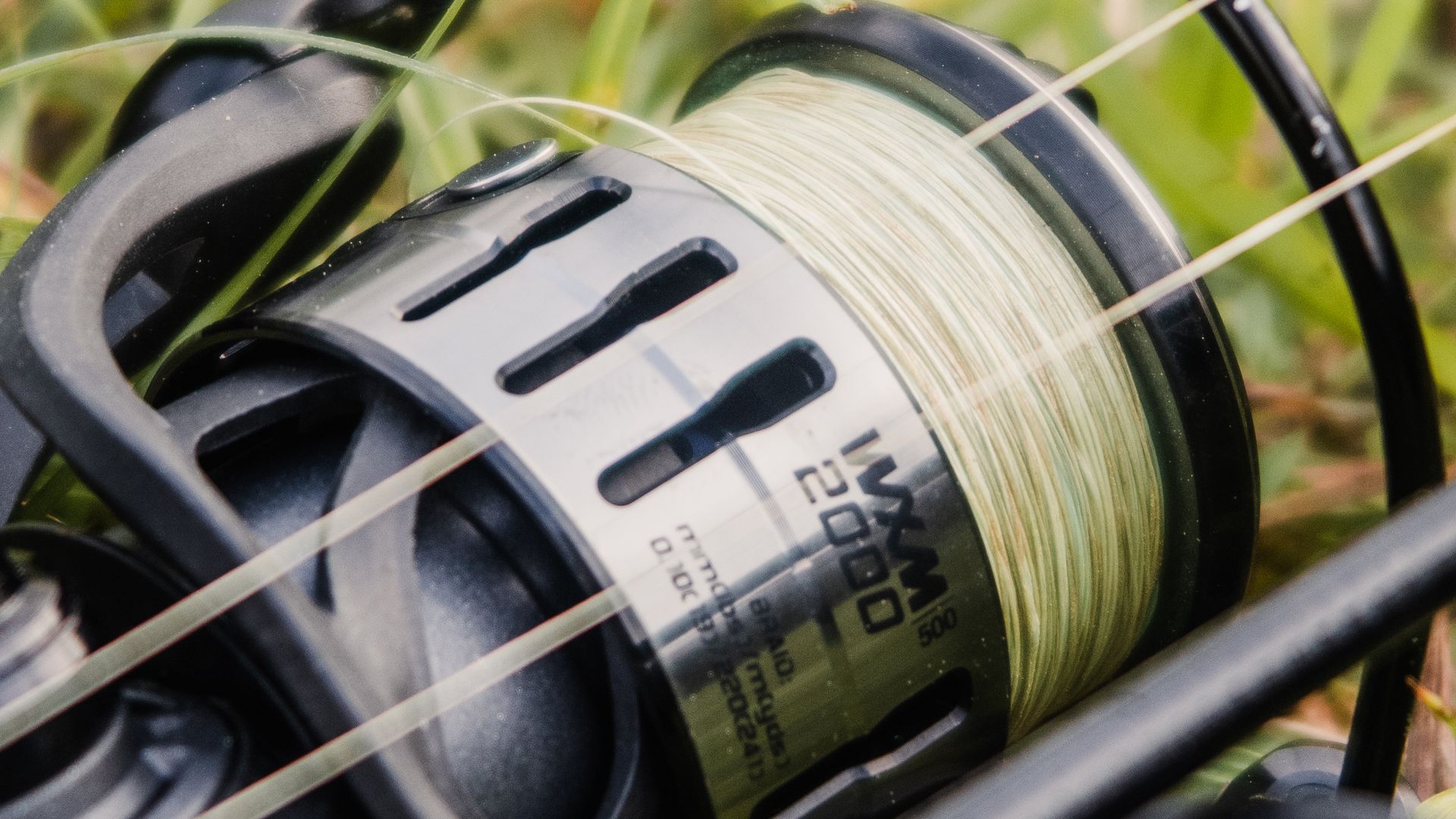 Close-up of a fishing reel spooled with braided fishing line