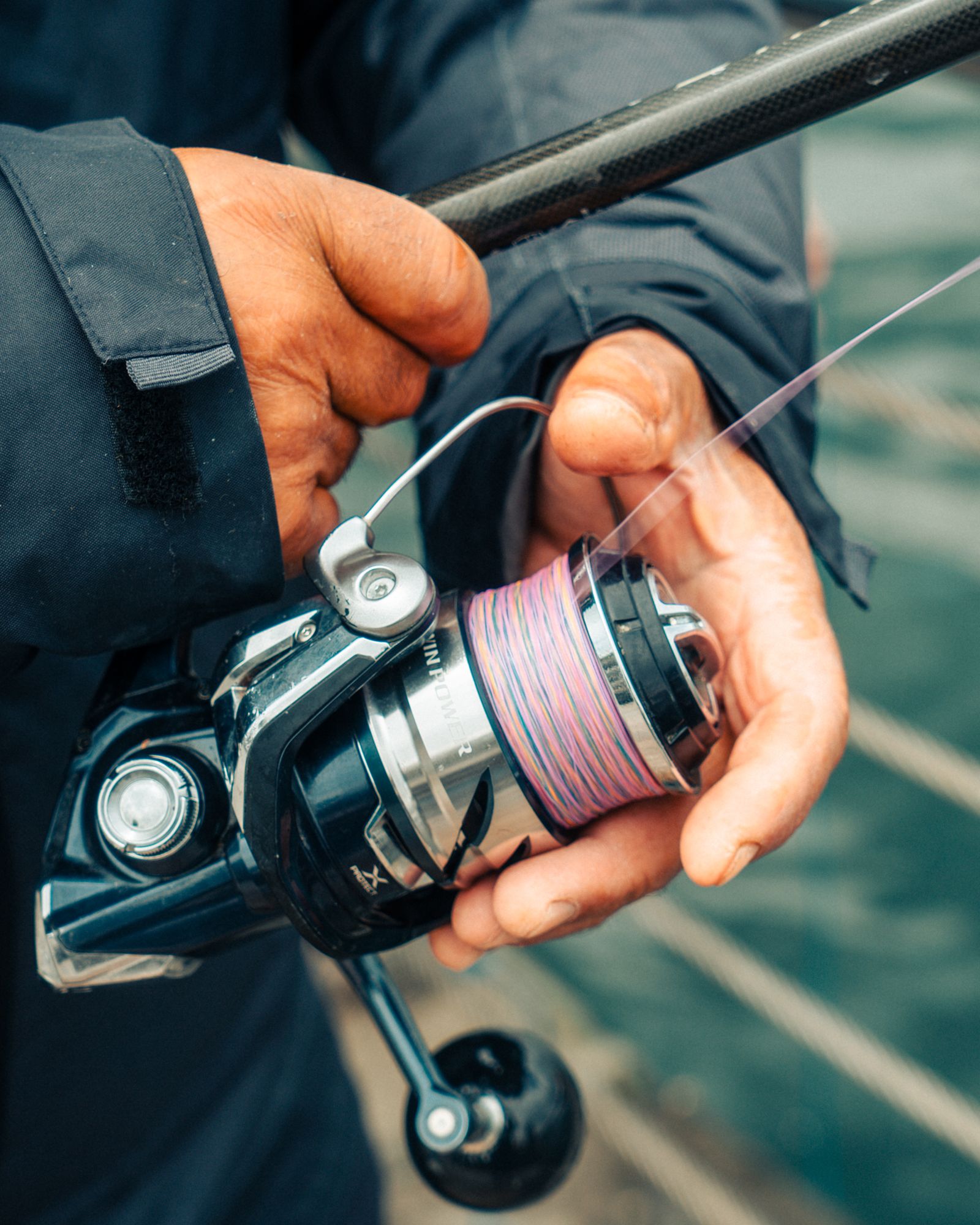 Angler holding a fishing reel loaded with line