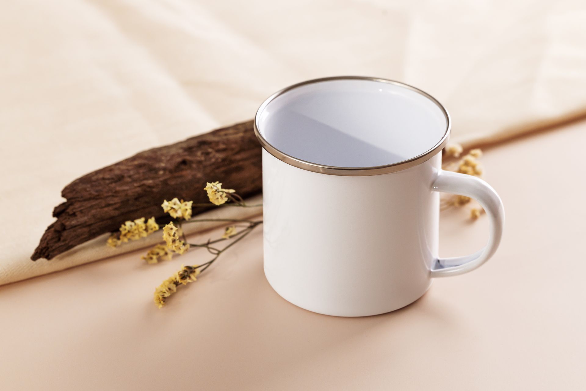 Clean white enamel camping mug on a wooden table