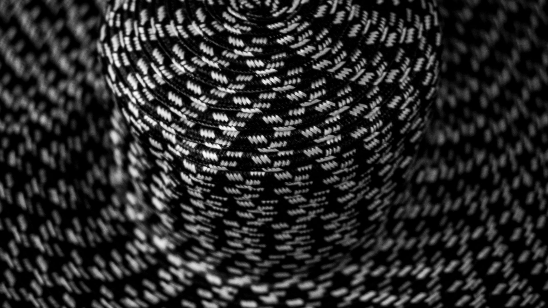 Coil of woven cord with reflective tracers